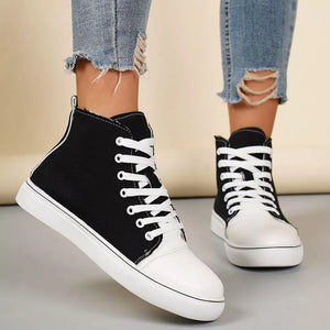 Black and white canvas high-top sneakers with white laces and soles.