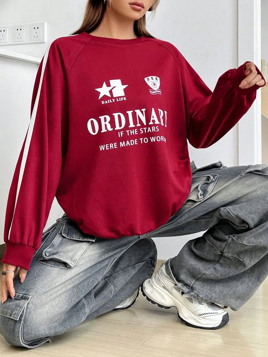 Deep red graphic raglan sleeve sweatshirt with white stripe detail on sleeves and "ORDINARY" text.