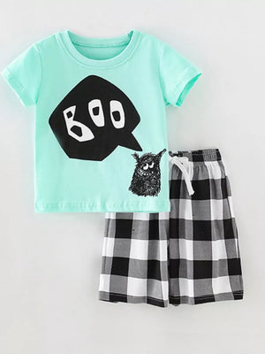 Kids' mint graphic tee with boo monster and black white buffalo plaid shorts with drawstring.