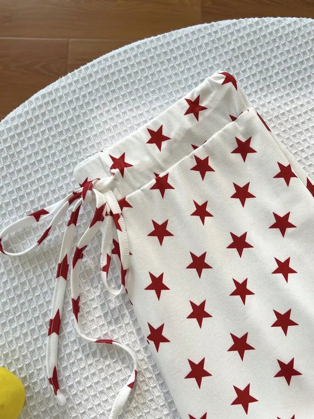 red pants featuring drawstring waist and star-print