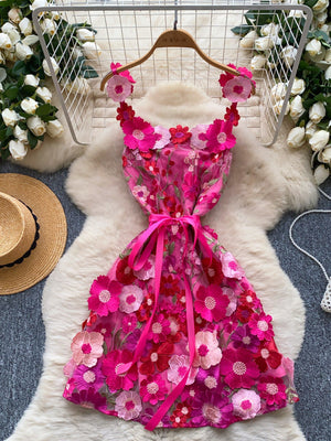 Embroidered floral mini dress in pink with applique flowers and a ribbon bow detail.