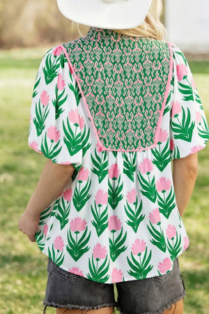White polyester blouse with pink floral print, green yoke, and puff sleeves.
