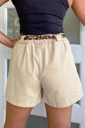 Beige linen shorts with elastic waist and leopard print belt detail