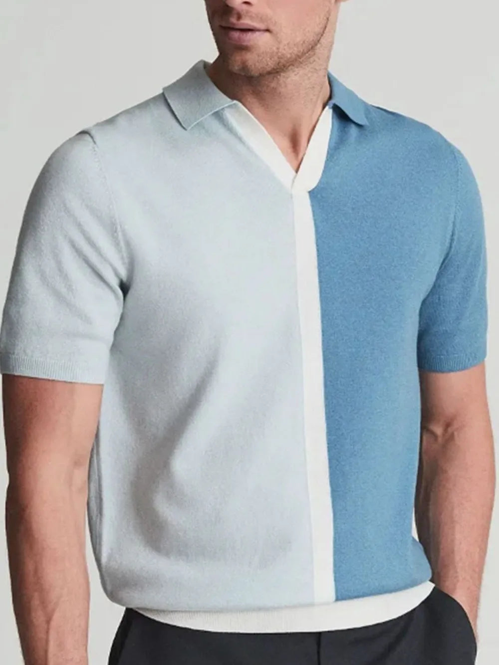 Colorblock knit polo shirt in cerulean with contrast placket and short sleeves.