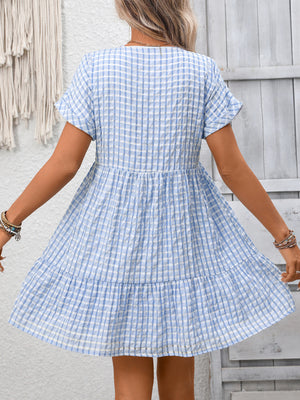 Light blue plaid V-neck mini dress with short sleeves and tiered skirt.