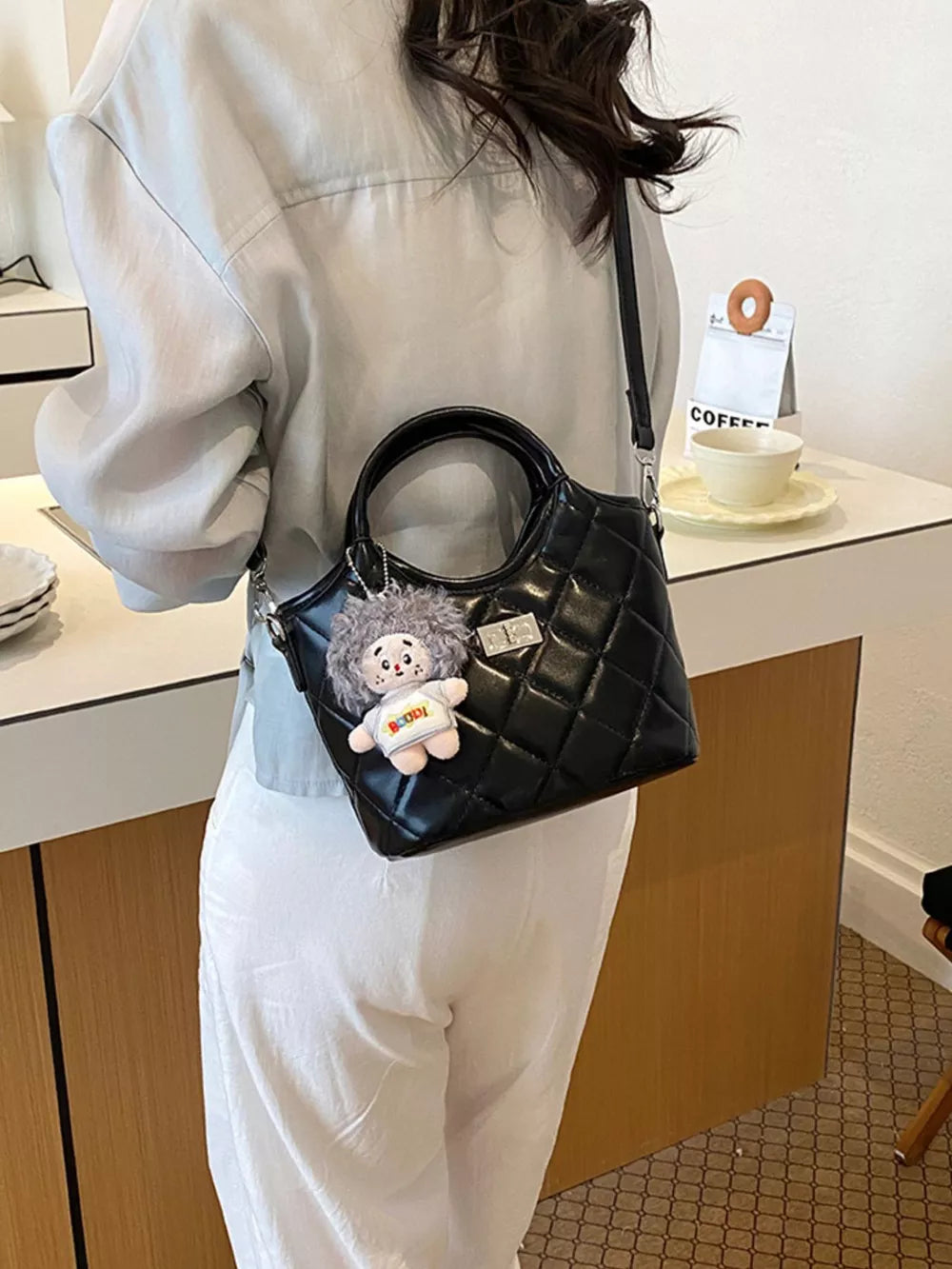 Black crossbody bag with turn-lock and quilted