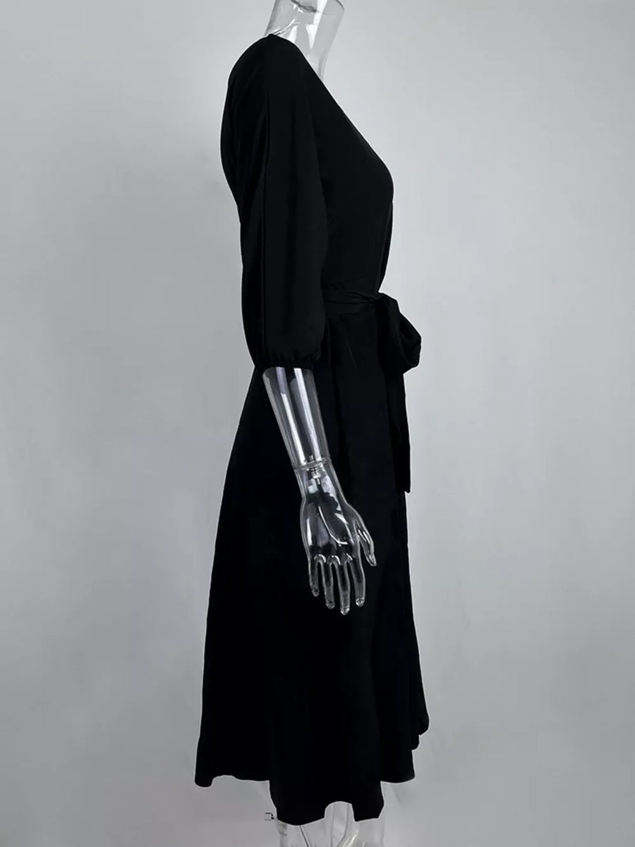 Black off-the-shoulder belted dress with 3/4 sleeves and a tie waist.