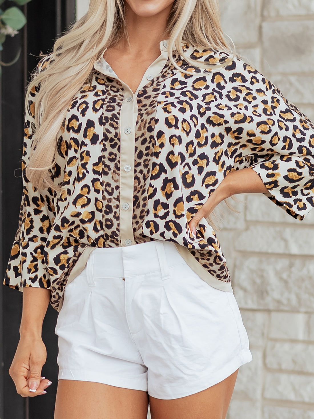 Print button-down shirt with leopard pattern, beige trim, and button cuffs.