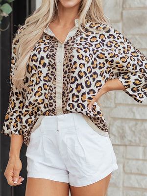 Print button-down shirt with leopard pattern, beige trim, and button cuffs.