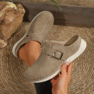 Khaki buckle accent round-toe slip-on flats with contrast stitching.