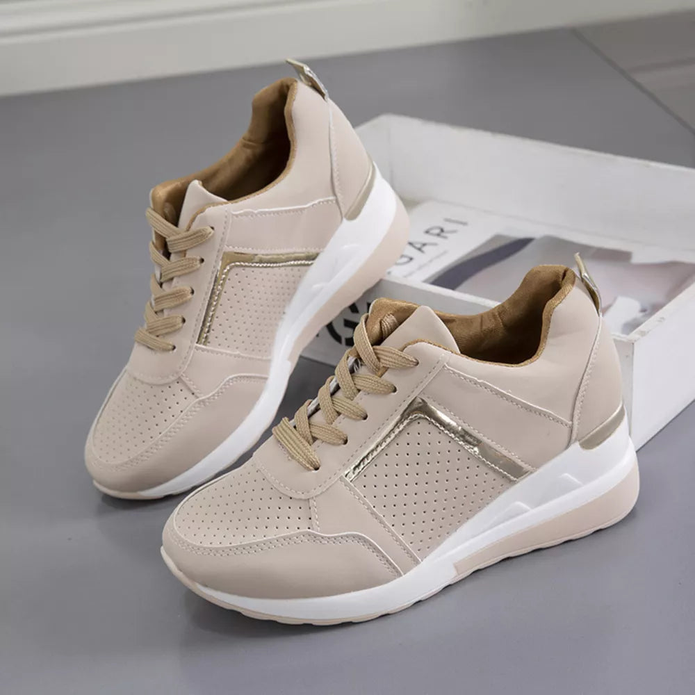 Beige lace-up wedge sneakers with metallic accents and perforated details.