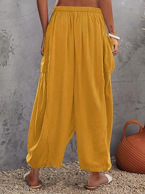 Mustard linen balloon pants with sculptural pocket detail.