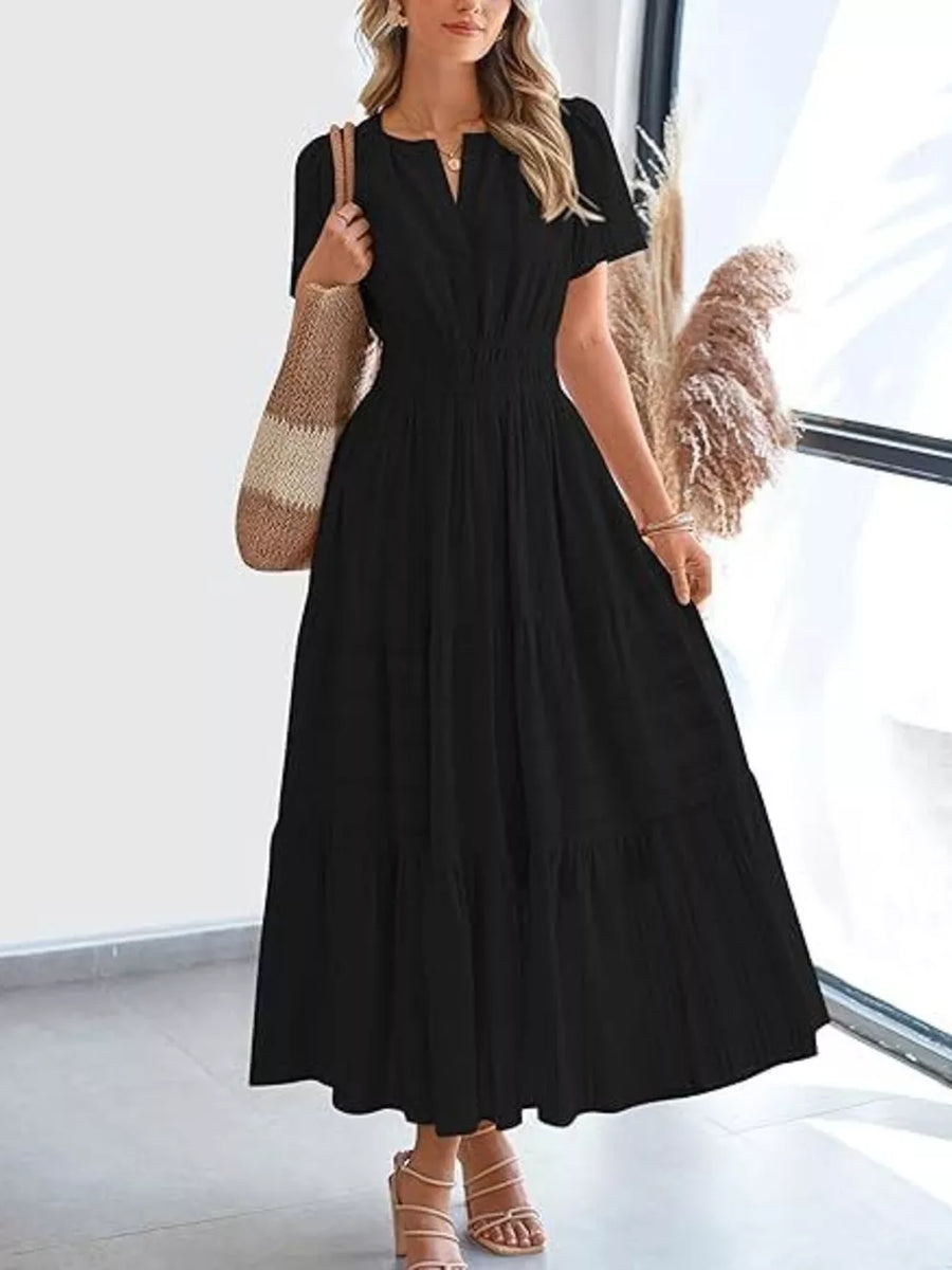 Black ruched V-neck tiered midi dress with short sleeves and smocked waist.
