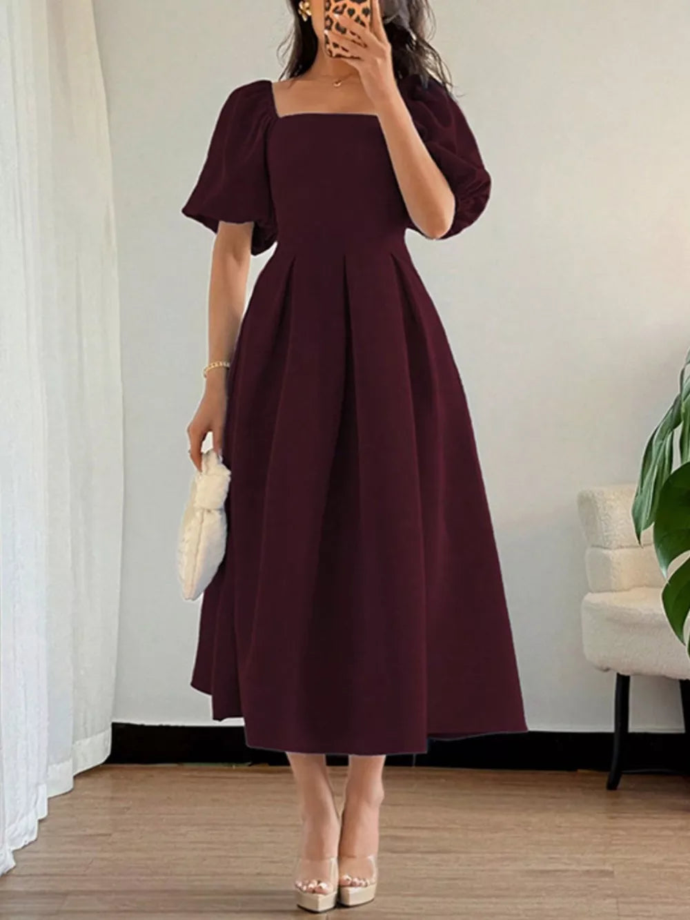 Burgundy midi dress with square neck, flutter sleeves, and full skirt.