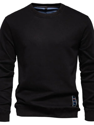 Black crewneck sweatshirt with subtle patch detail on hem