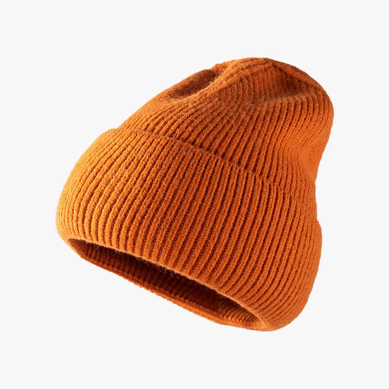 Ribbed knit slouch beanie in Rust with a cuffed hem.