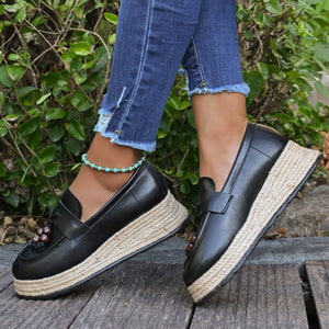 Black espadrille wedge slip-on loafers with braided jute detail.