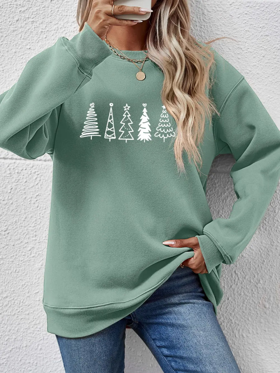 Sage green oversized sweatshirt with white festive tree graphic, crewneck, long sleeves.