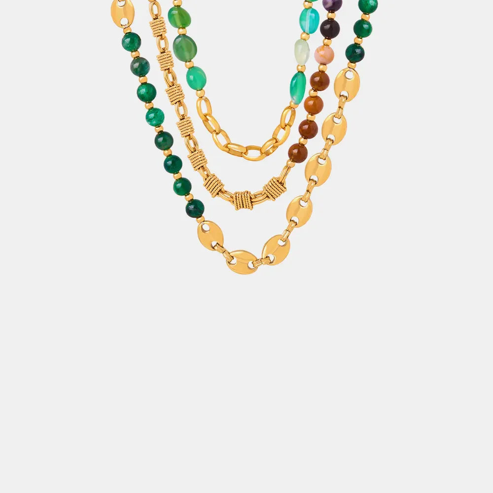Gilded bead and chain statement necklace with green and mixed color beads.