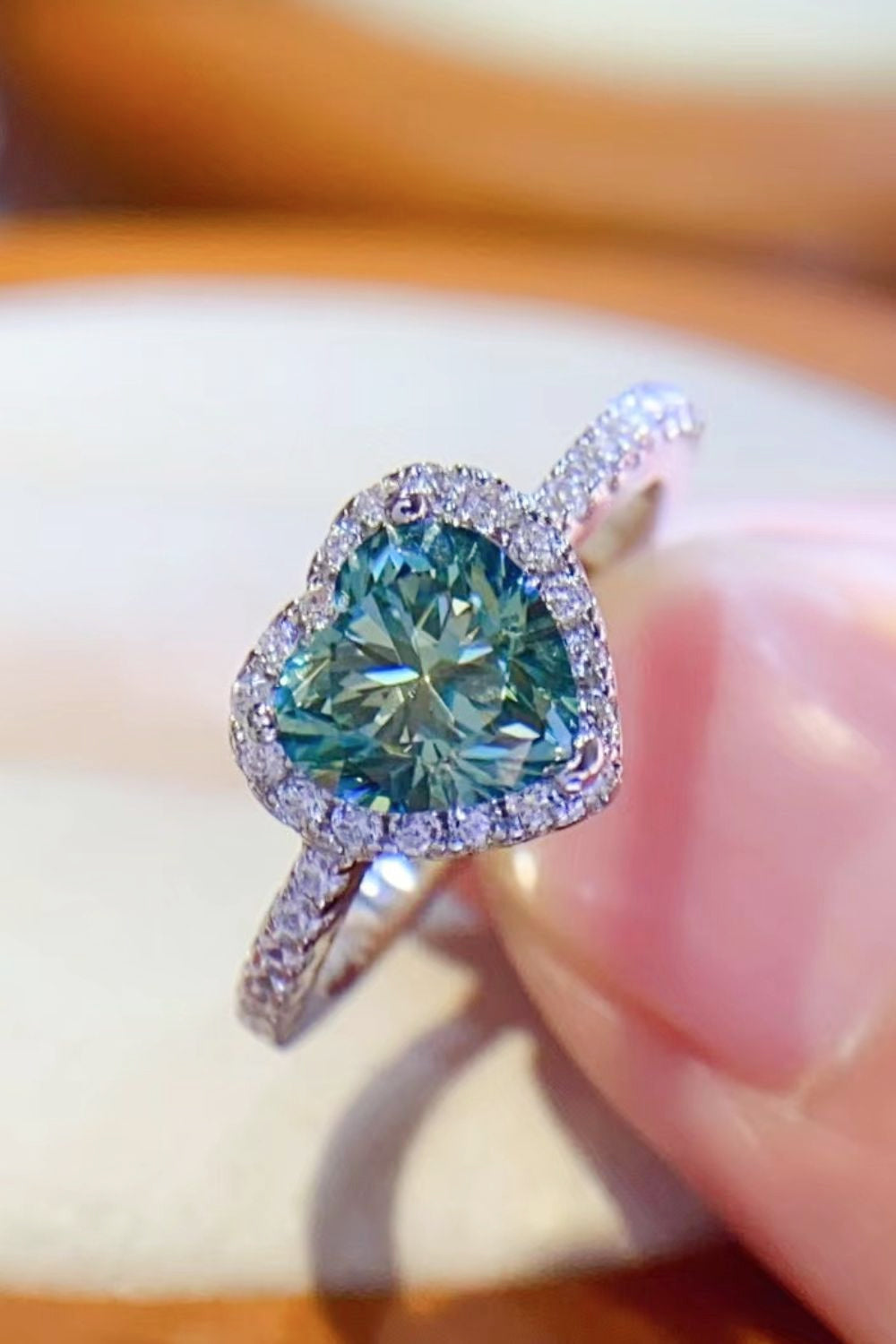 Heart-cut green moissanite halo ring with diamond band