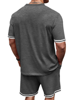 Men's grey t-shirt and shorts set with white and black striped trim on sleeves and hem