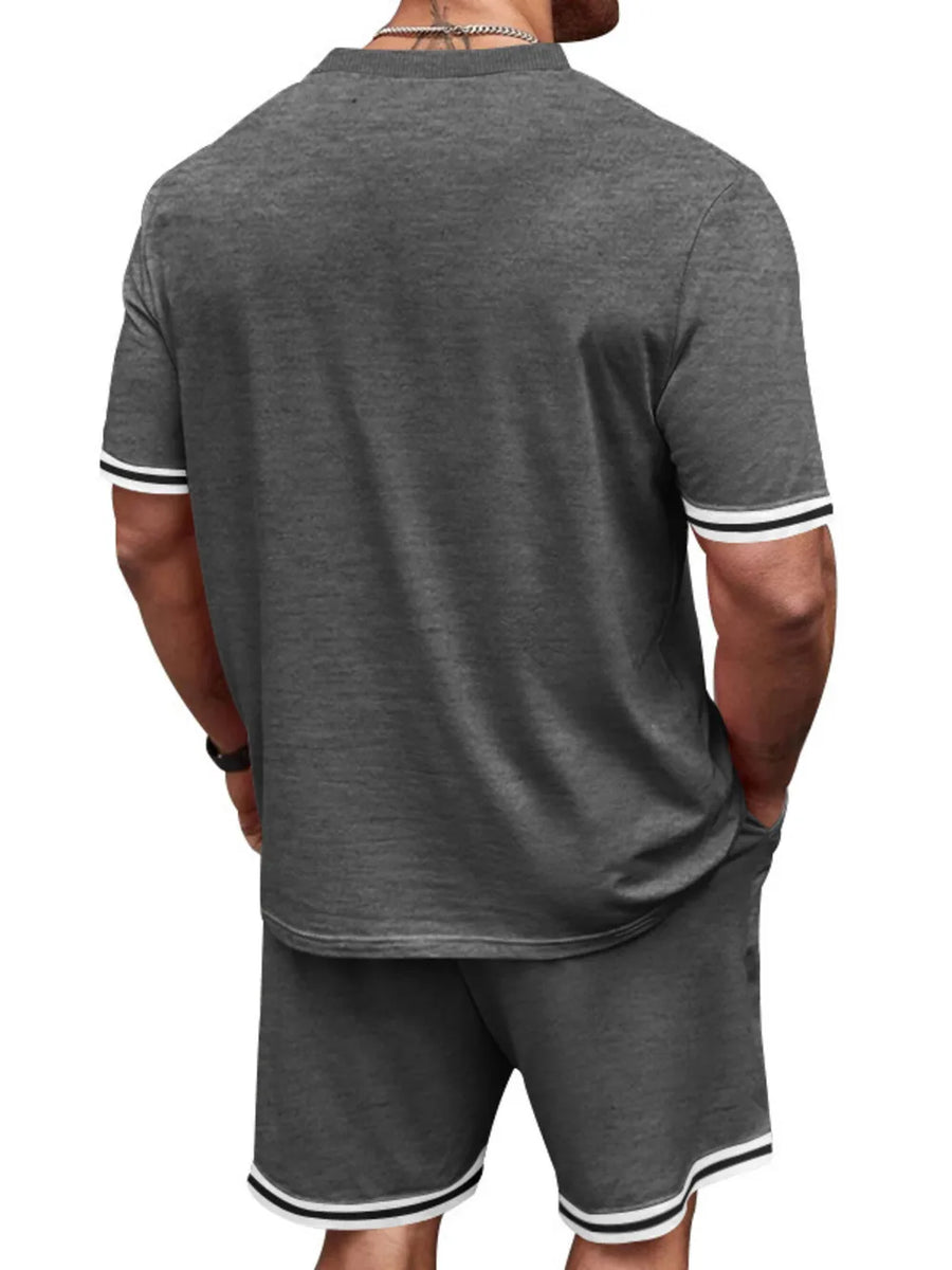 Men's grey t-shirt and shorts set with white and black striped trim on sleeves and hem