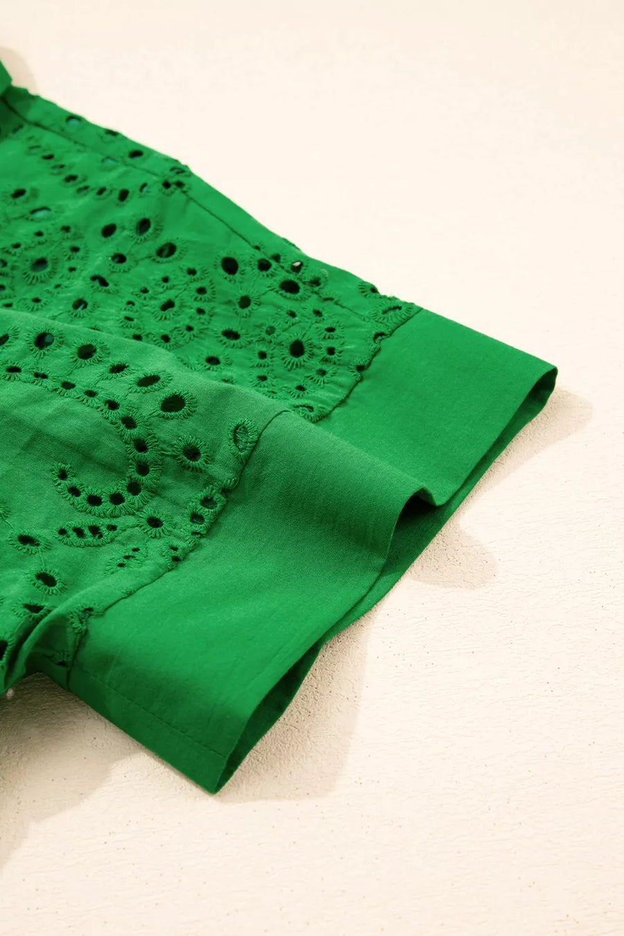 Green cotton eyelet collared dress with scalloped hem detail.