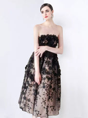 Black strapless midi dress with 3D floral applique and a-line skirt.