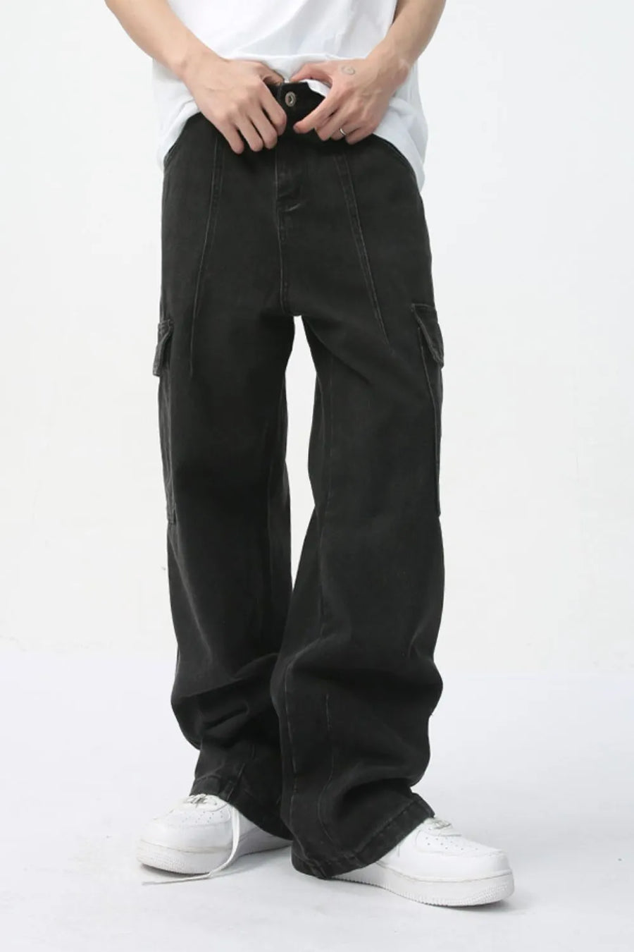 Wide-leg dark wash denim cargo pants with utility pockets and a relaxed fit.