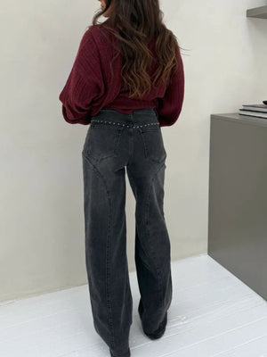 Dark gray studded high-waisted wide-leg jeans with button fly.