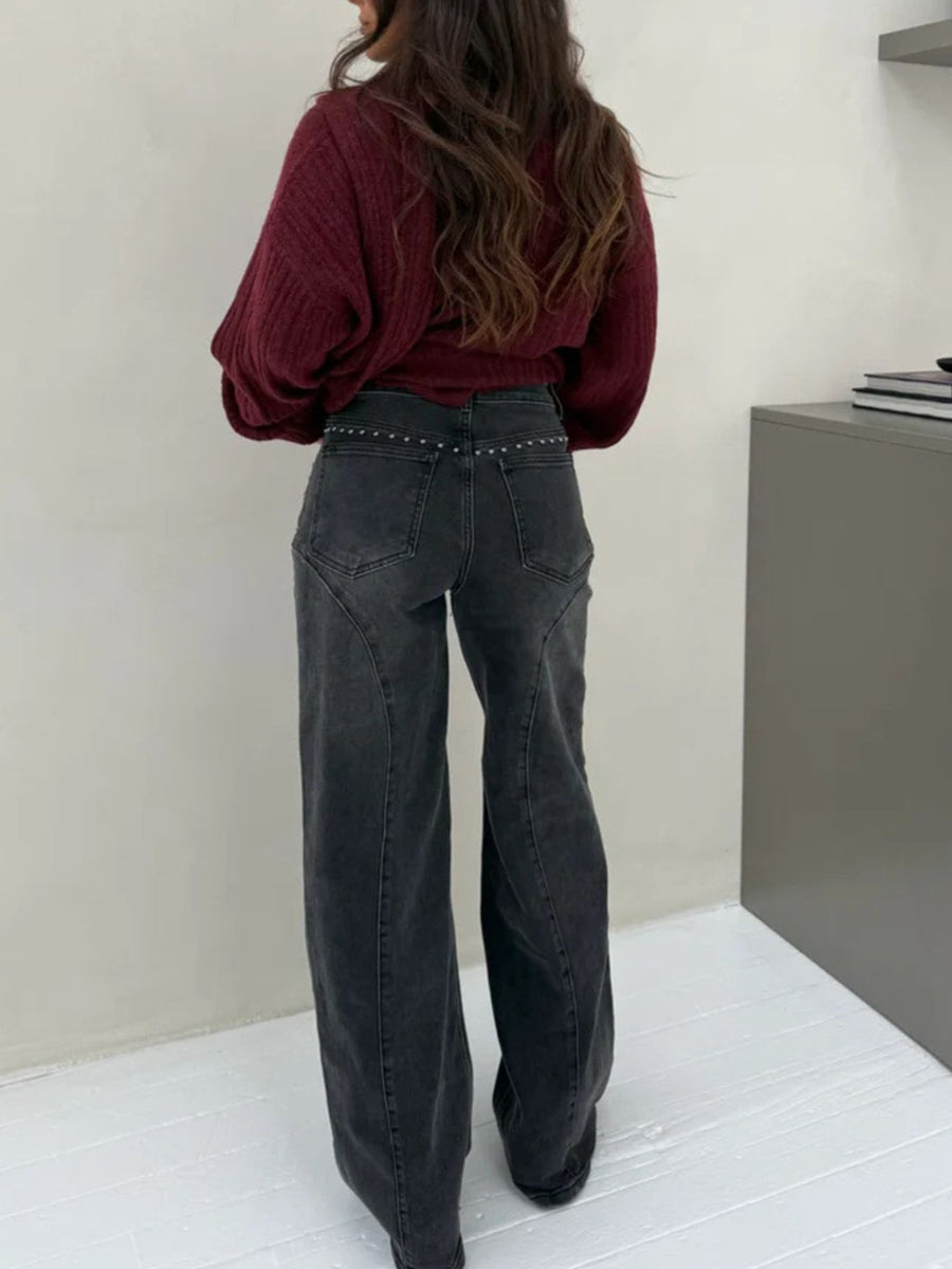 Dark gray studded high-waisted wide-leg jeans with button fly.