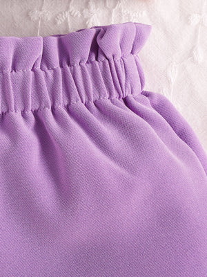 Purple baby set with ruffled waist and bow detail, cotton fabric.