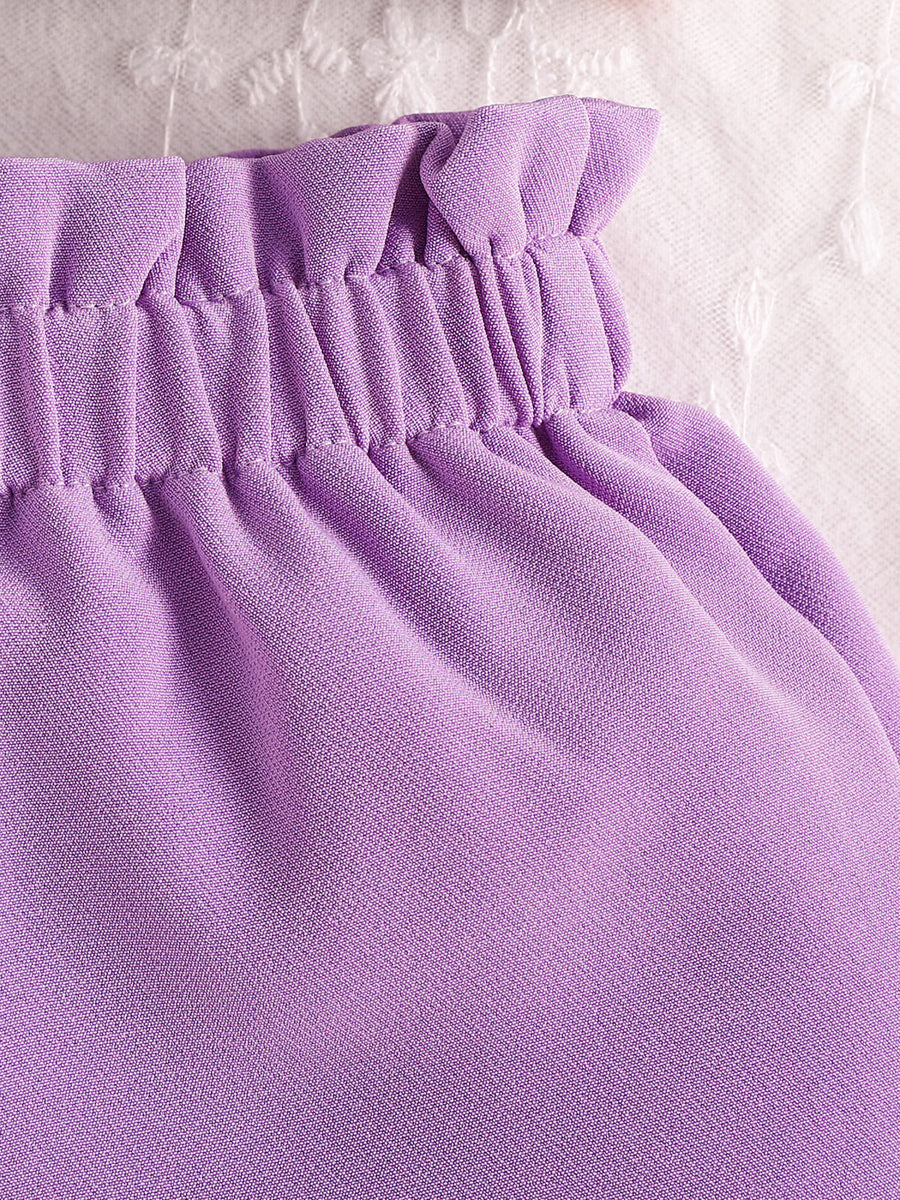 Purple baby set with ruffled waist and bow detail, cotton fabric.