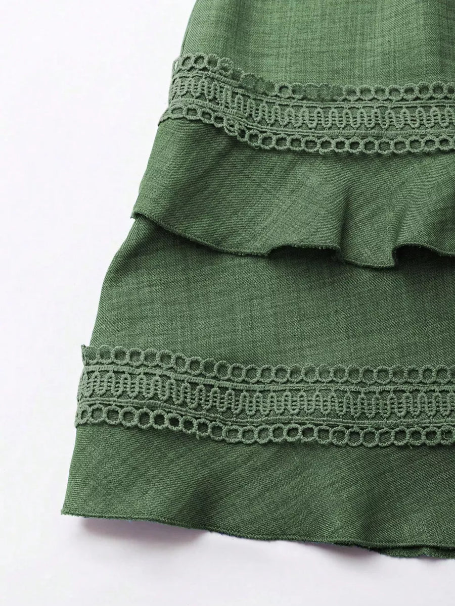 Green tiered mini dress with lace trim detail