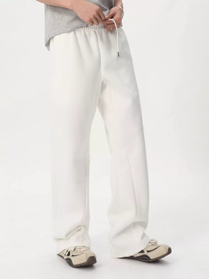 White relaxed fit sweatpants with adjustable drawstring waist and wide leg.