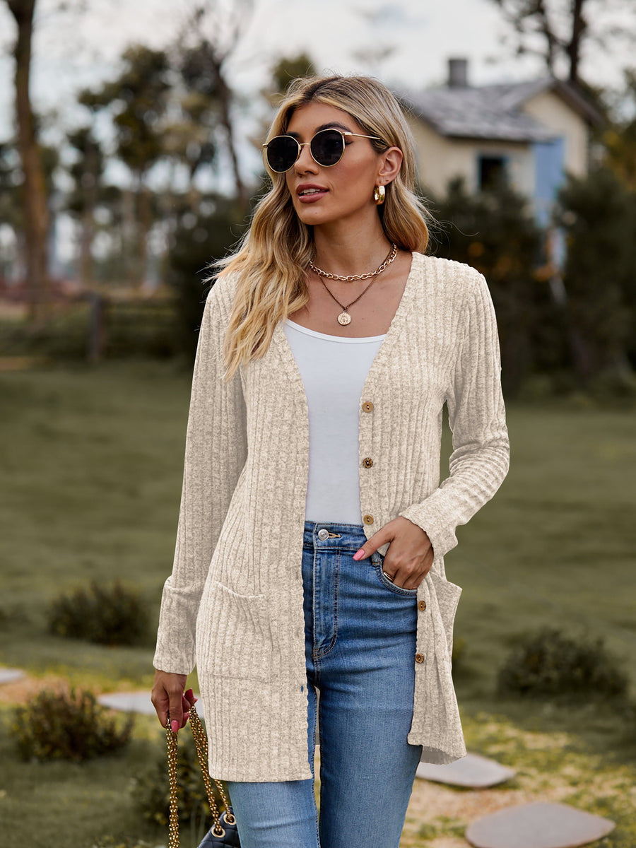 Beige ribbed knit longline button-down cardigan with pockets and cuffed sleeves.