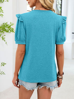 Lake blue short-sleeve t-shirt with ruffled shoulders and a V-neck, styled with denim shorts.