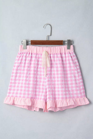 Pink gingham cotton shorts with drawstring and ruffle hem detail.