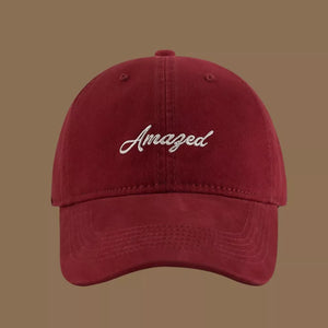 Wine red cotton baseball cap with white embroidered "Amazed" text.