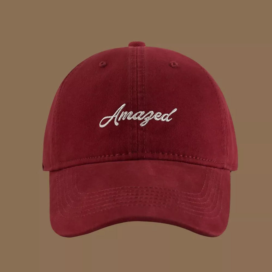 Wine red cotton baseball cap with white embroidered "Amazed" text.