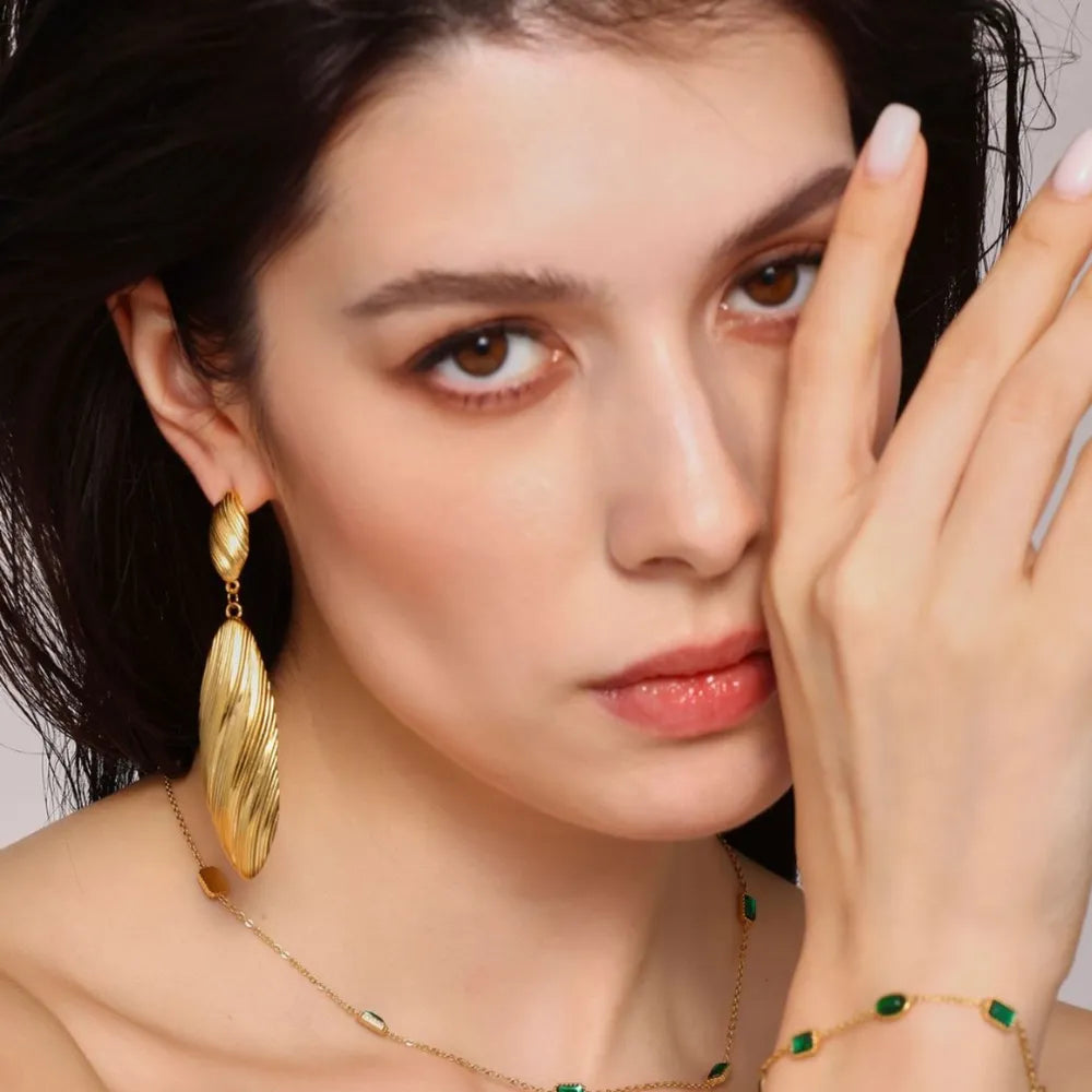 Textured gold leaf drop earrings with ribbed detail.