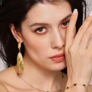 Textured gold leaf drop earrings with ribbed detail.
