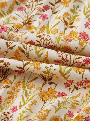Floral print loose shirt dress fabric with pink, yellow, and green wildflowers.