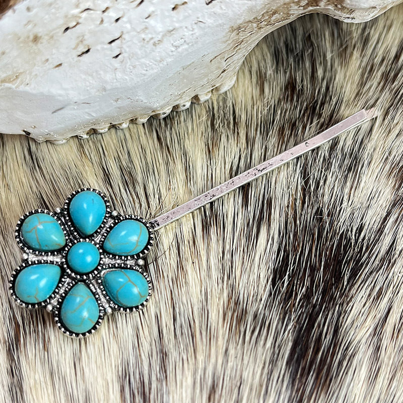 Turquoise blossom hair pin with alloy metal and faux turquoise stones.