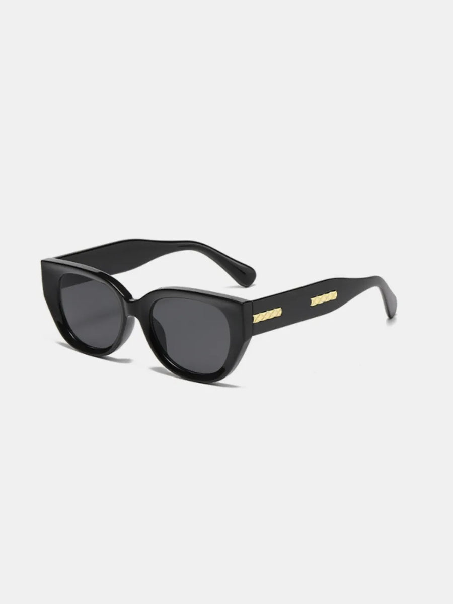 Black sculpted cat eye sunglasses with gold accents on the temples.