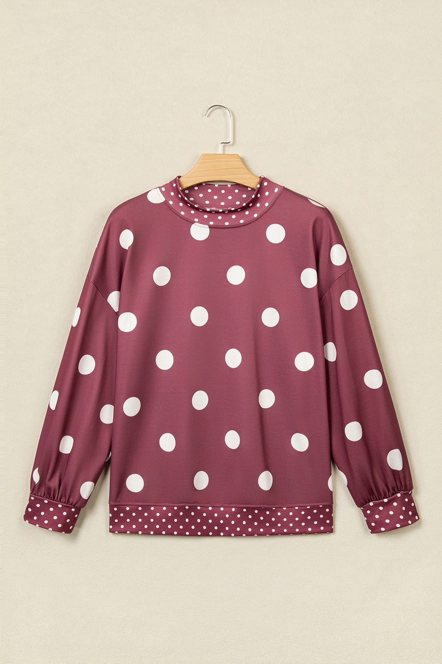 light pink sweatshirt featuring oversized and polka dot