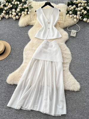 White sheer two-piece set with V-neck sleeveless top and flowing skirt, button details