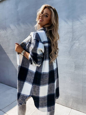 Checkered sport jacket in black and white with a collar, worn open by a model.