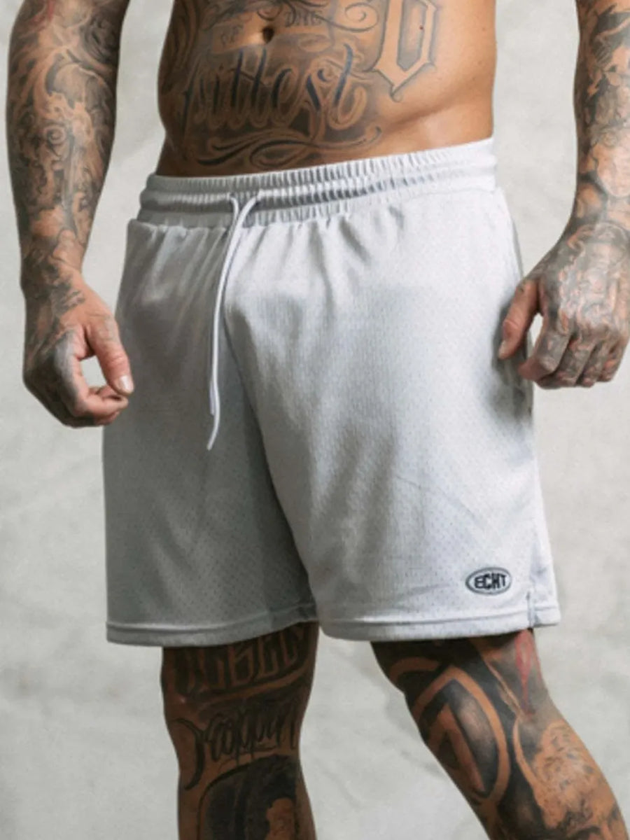 Light gray perforated performance drawstring shorts with a mesh texture and embroidered logo detail.