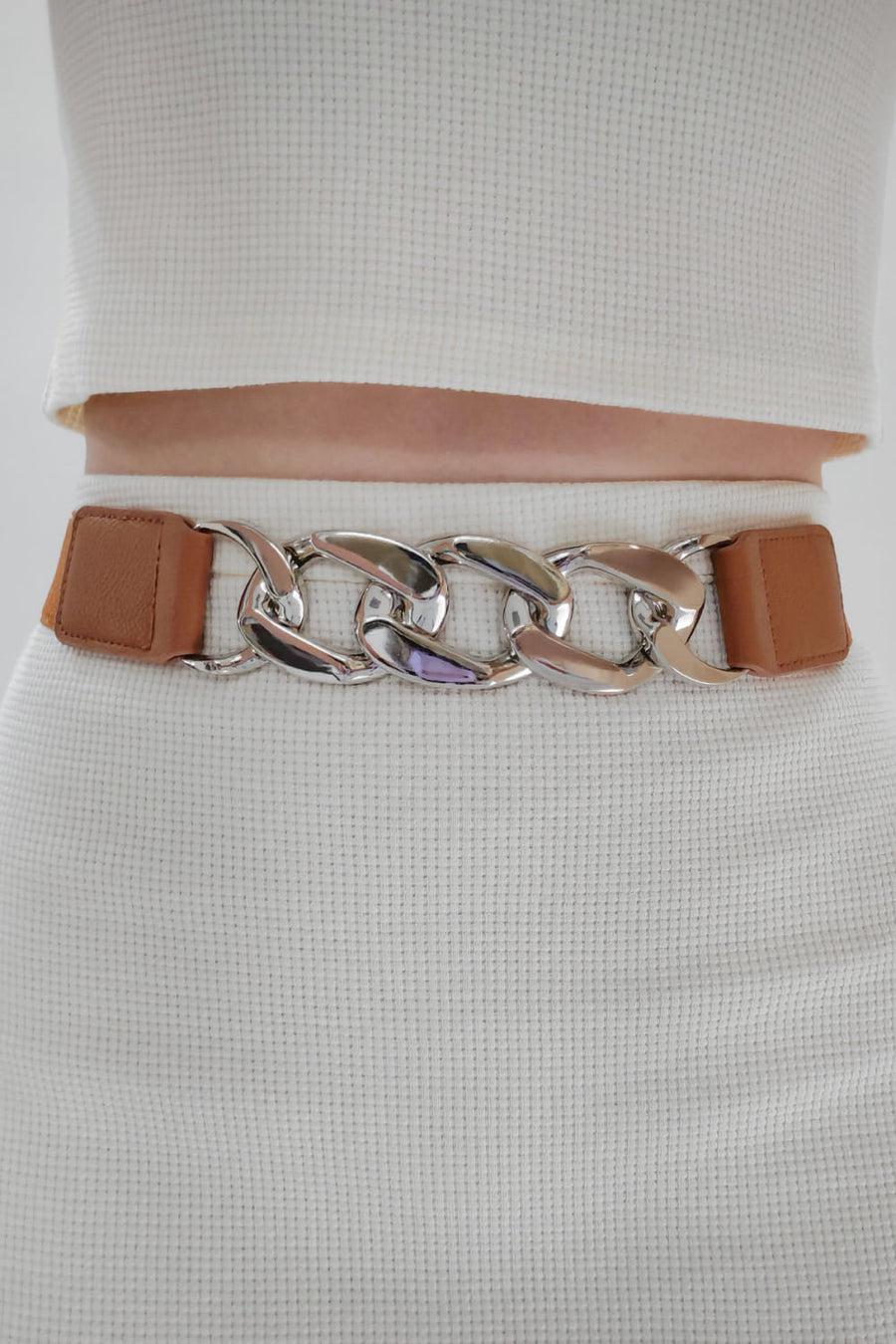 Chunky chain elastic belt with tan faux leather ends and silver alloy links.
